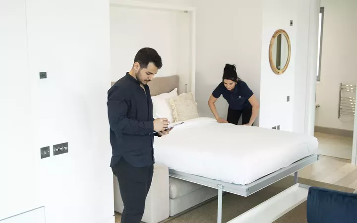 United Facilities hospitality team preparing a guest room